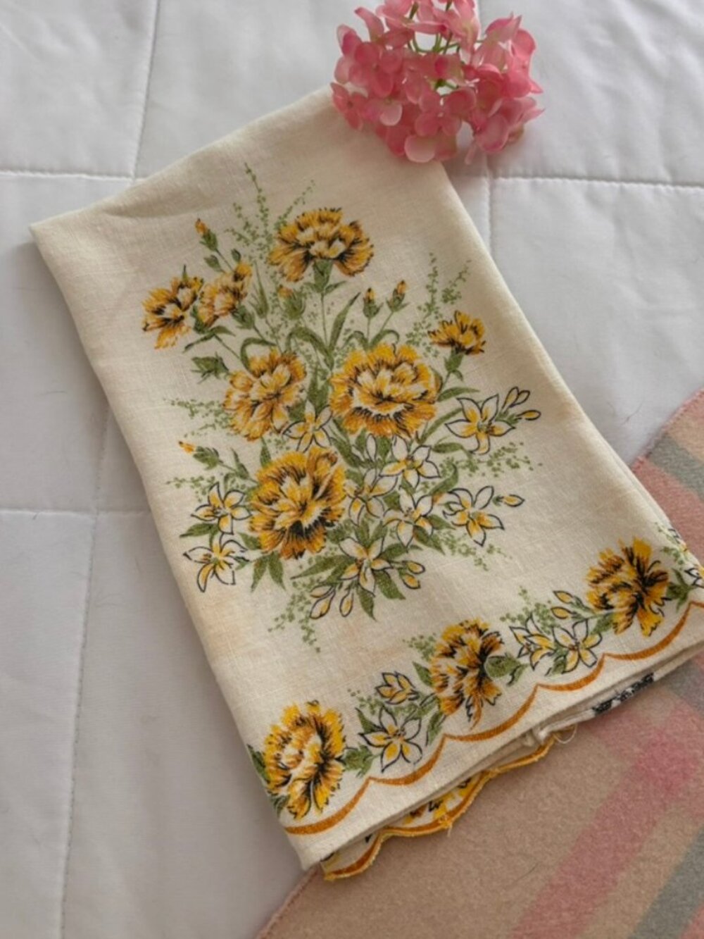 Vintage Tea Towel features a vibrant yellow floral print scalloped edge